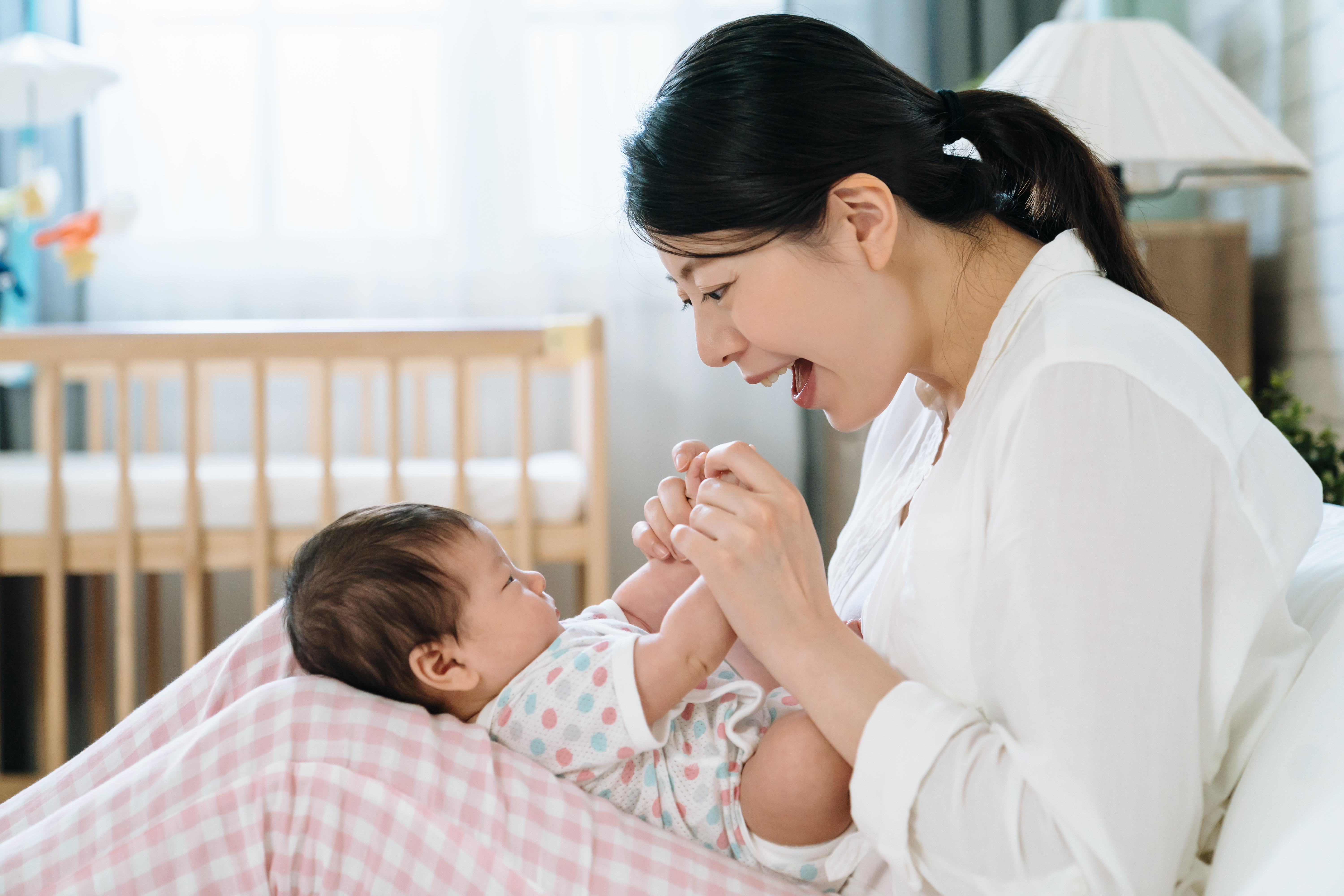 parent singing to baby on their lap