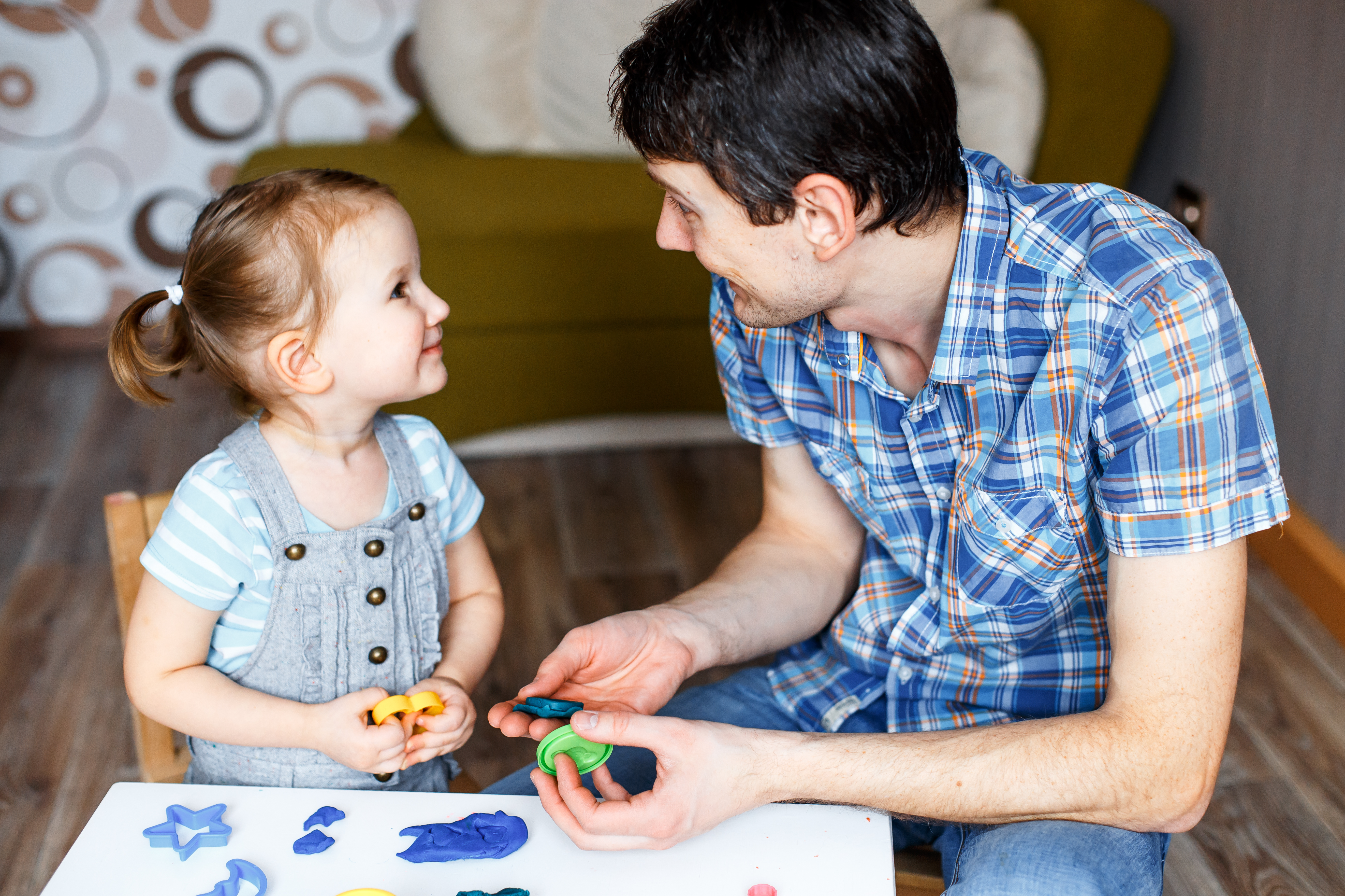 parent and young child playing with playdough