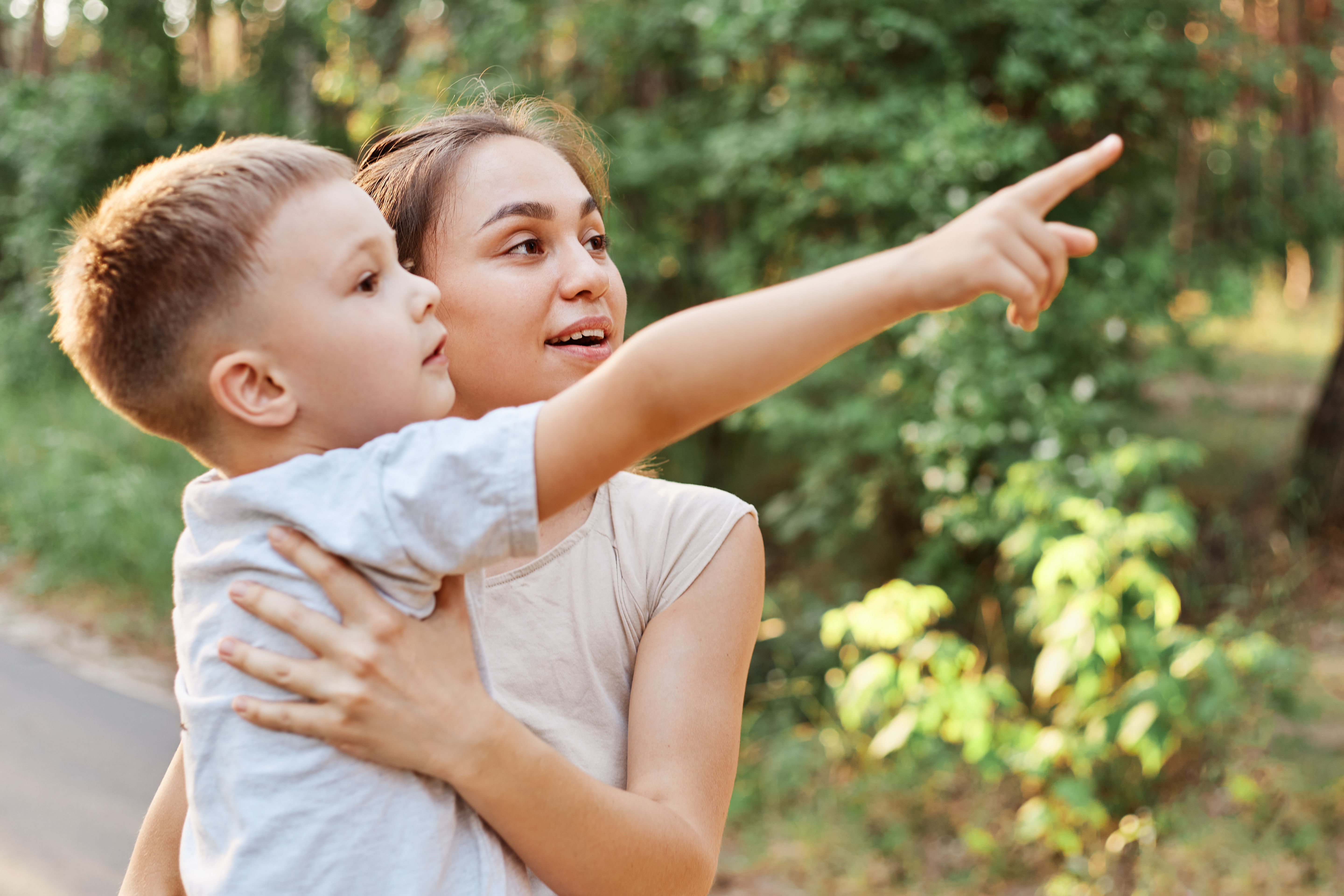 image of a woman holding a young child who is pointing