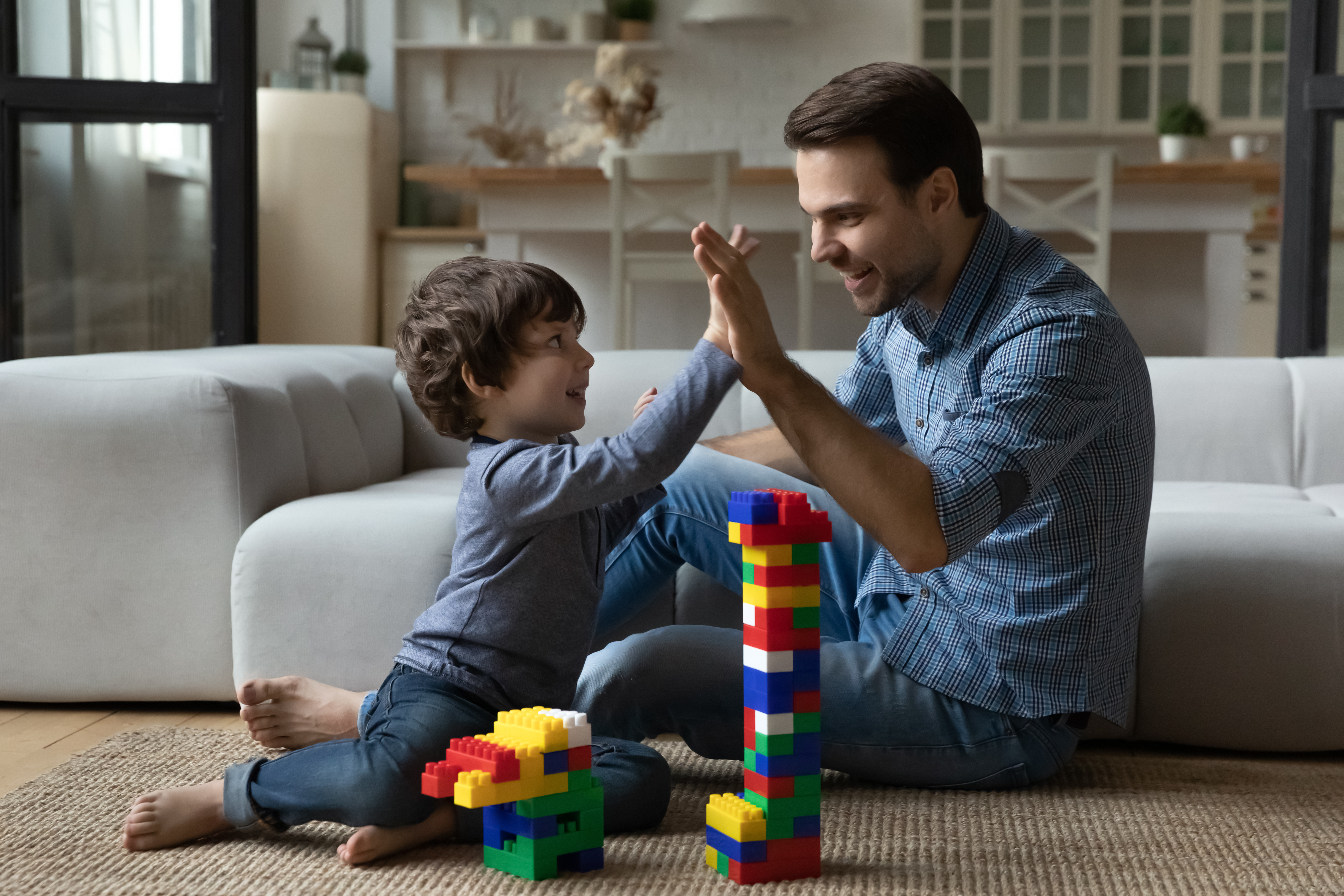 image of a young child and parent high-fiving