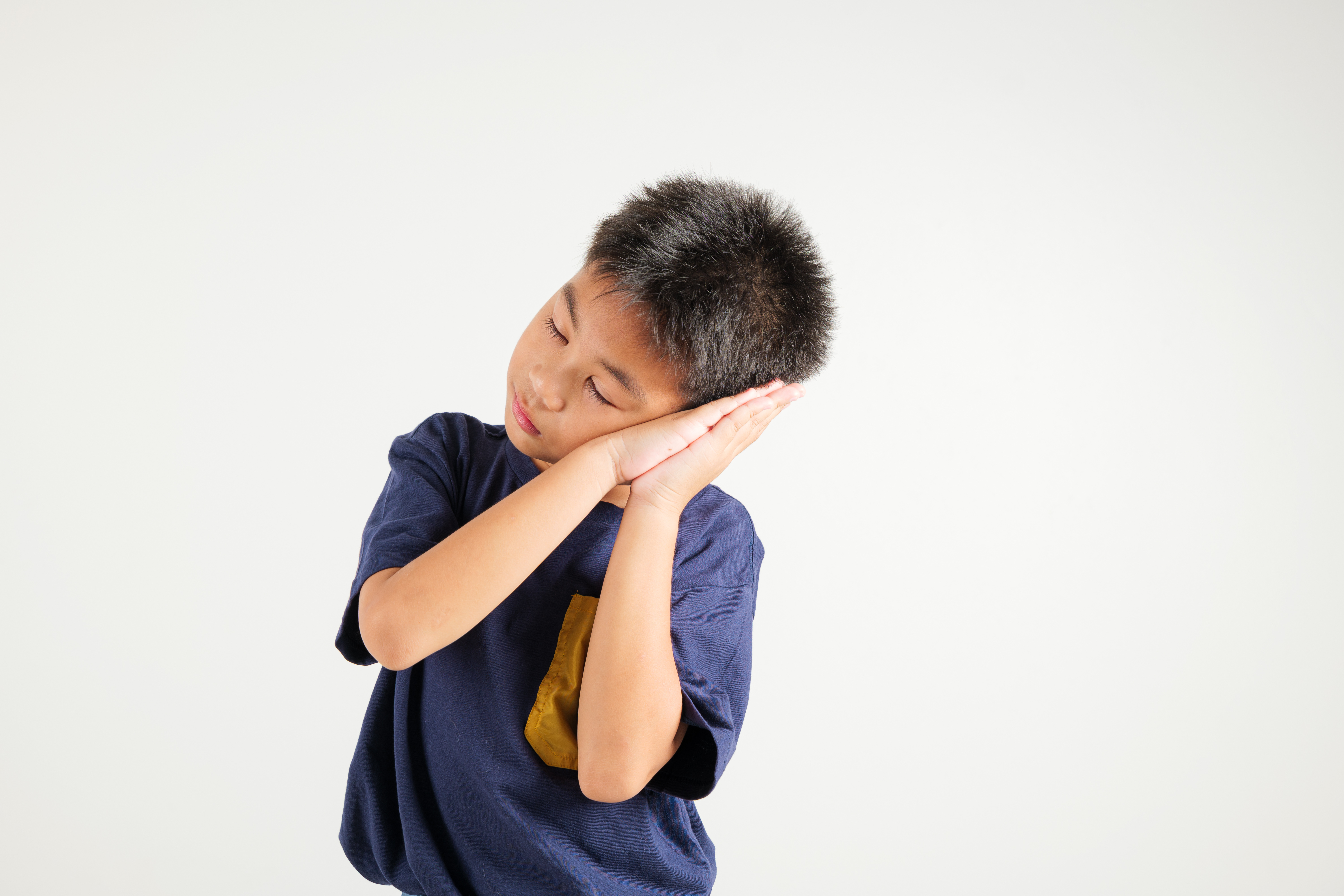 image of a young child miming "sleep"
